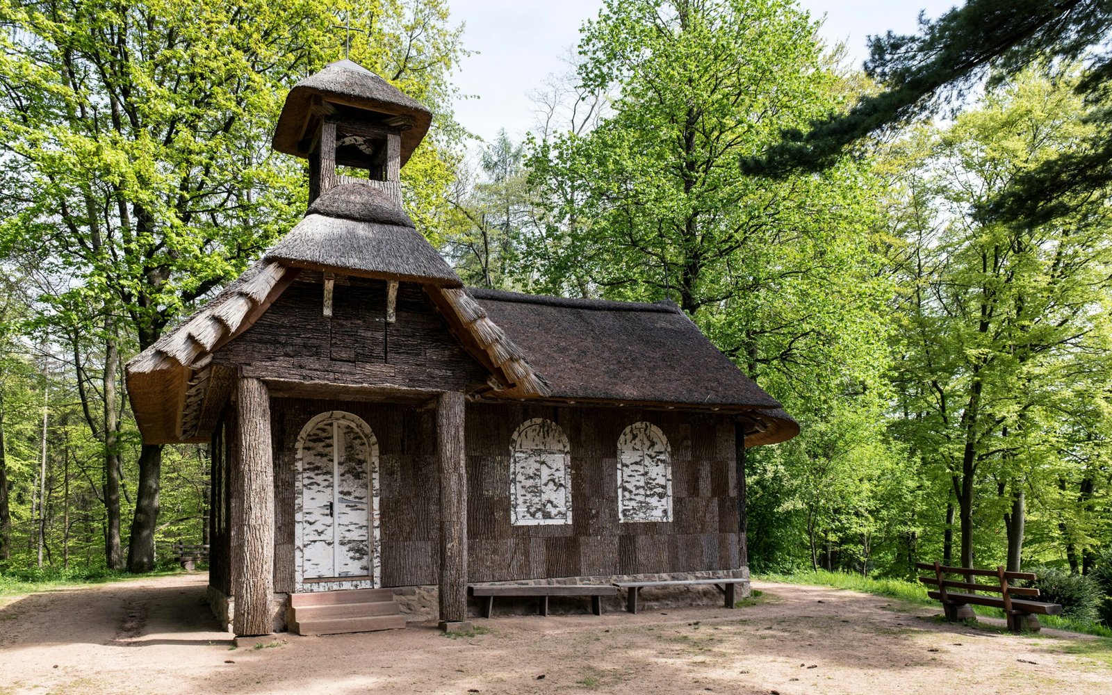 a small wooden building with a thatched roof